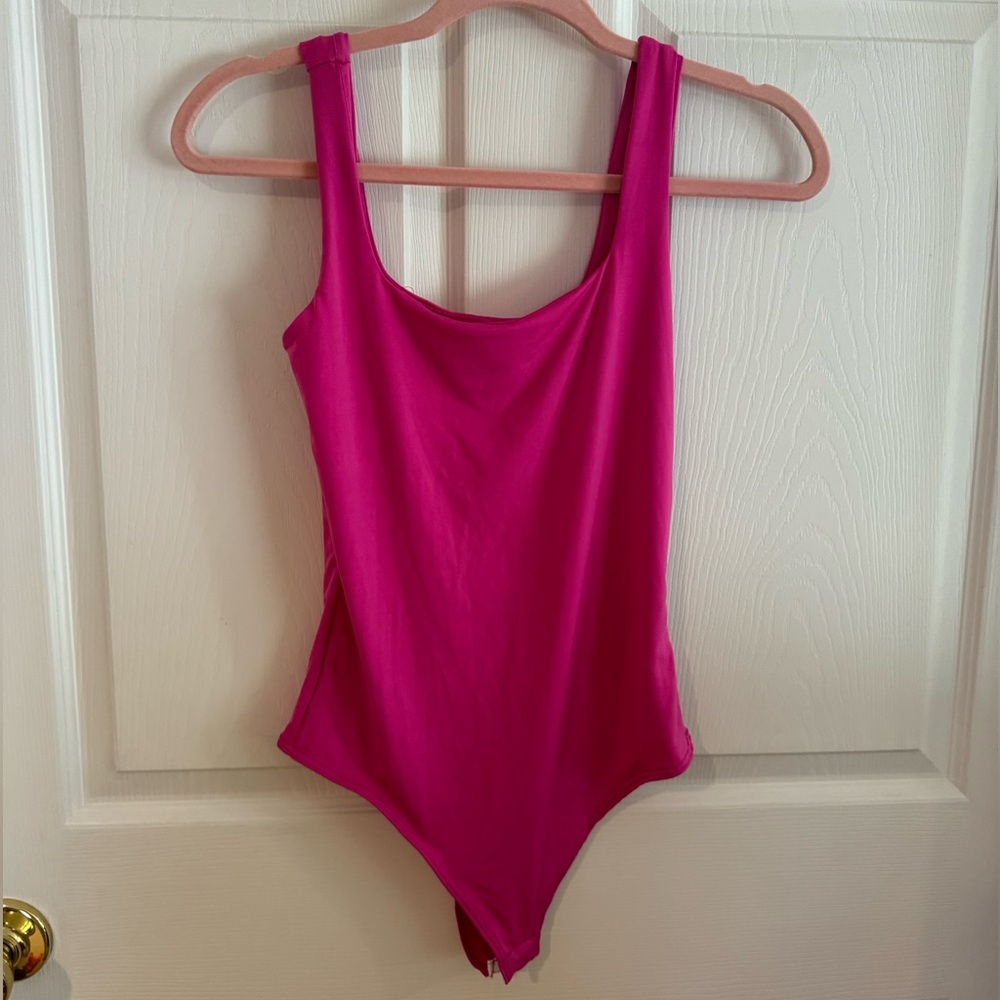 Bright pink body suit